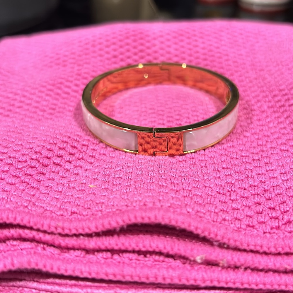 Kate Spade large bangle. Cream and gold with gold decorations for on the cream.